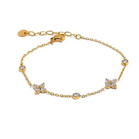 Bracelet Elisa en acier inoxydable doré et diamant sur fond blanc. Le bracelet a des fleurs en diamant.